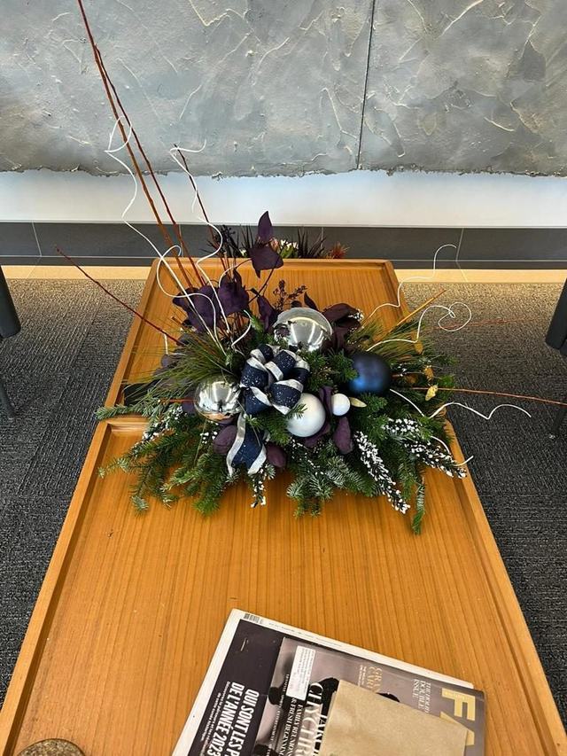 Festive centrepiece with navy and silver baubles on a wooden table