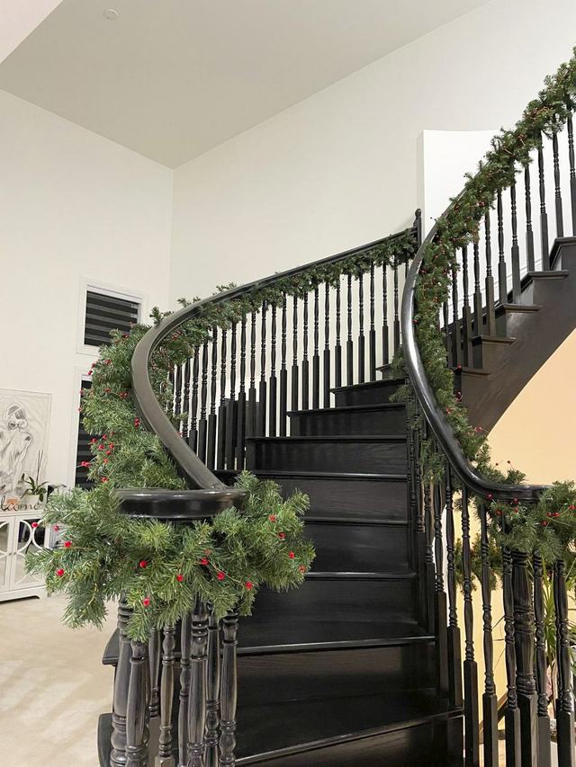 Garland wrapped around a curved staircase banister