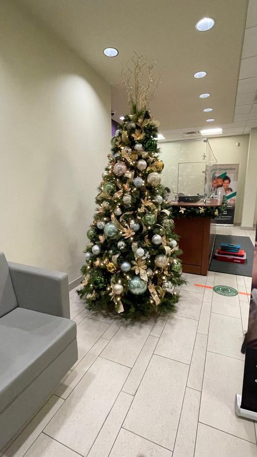 Gold and silver decorated Christmas tree in a small office reception