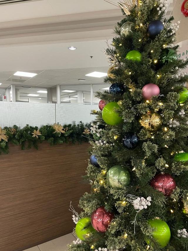 Close-up of a Christmas tree with lime green, pink and navy baubles